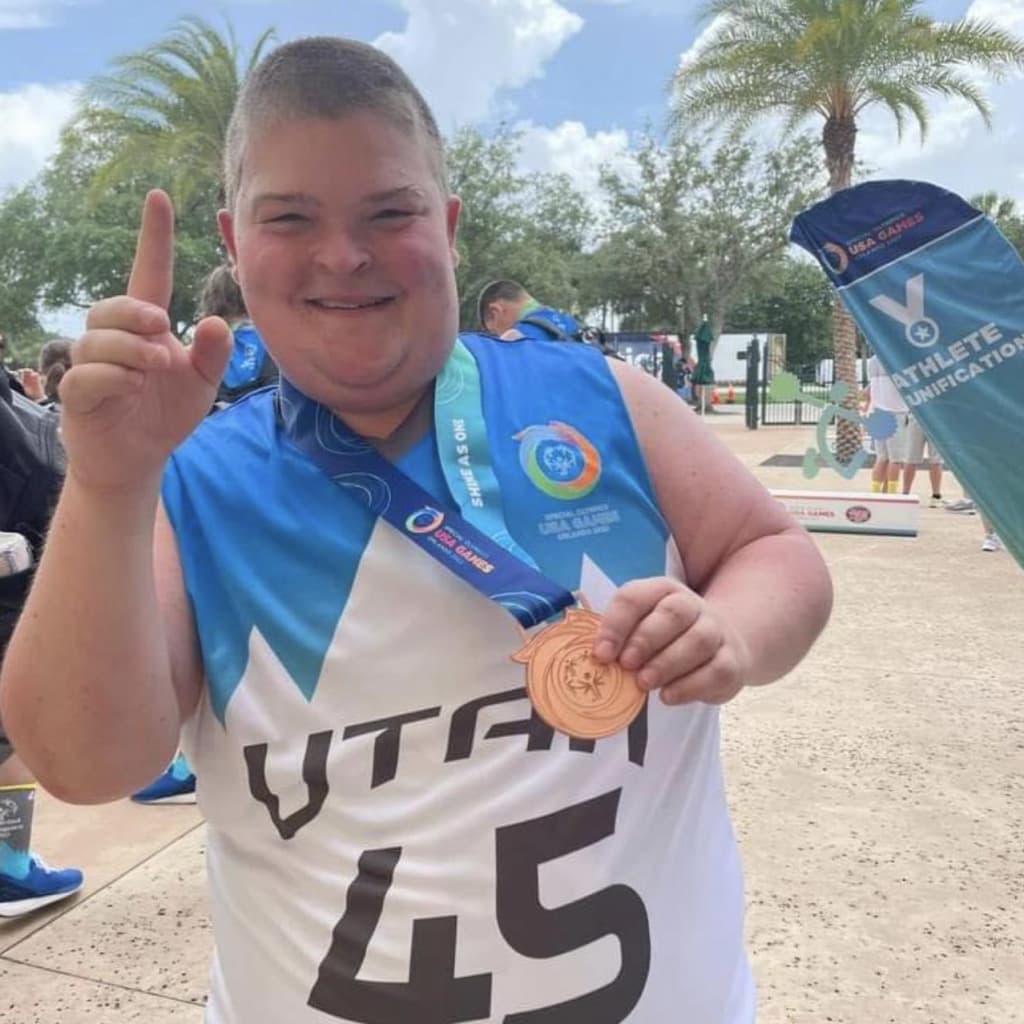 Kollyn Heffernan holding a medal after completing an outdoor race
